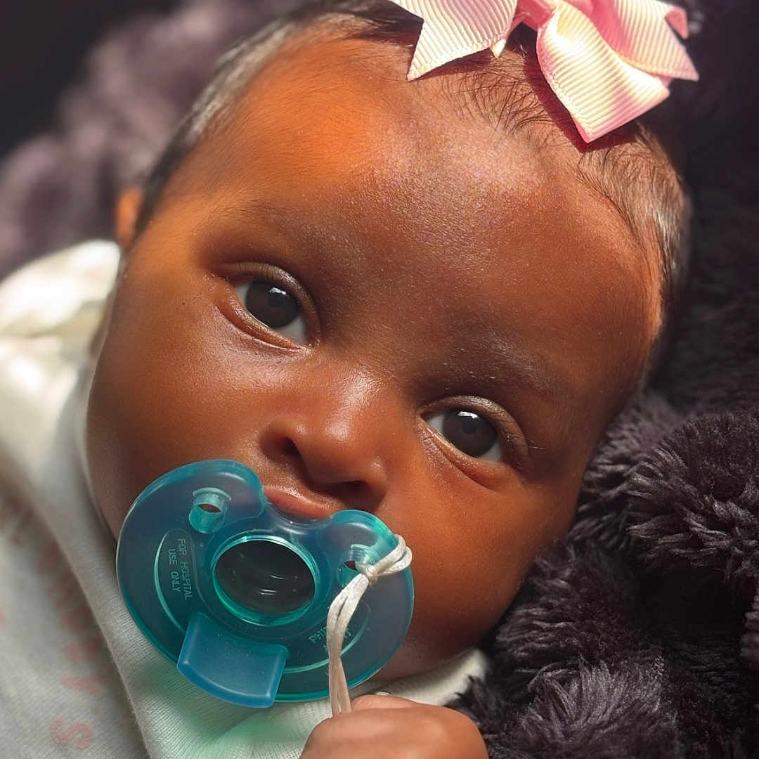 Kyla joined the competition — help win amazing prizes! accessories, baby, biting, bodypart, clothing, earring, face, finger, hand, happy, hat, head, jewelry, newborn, person, photography, portrait, purple, smile, toy