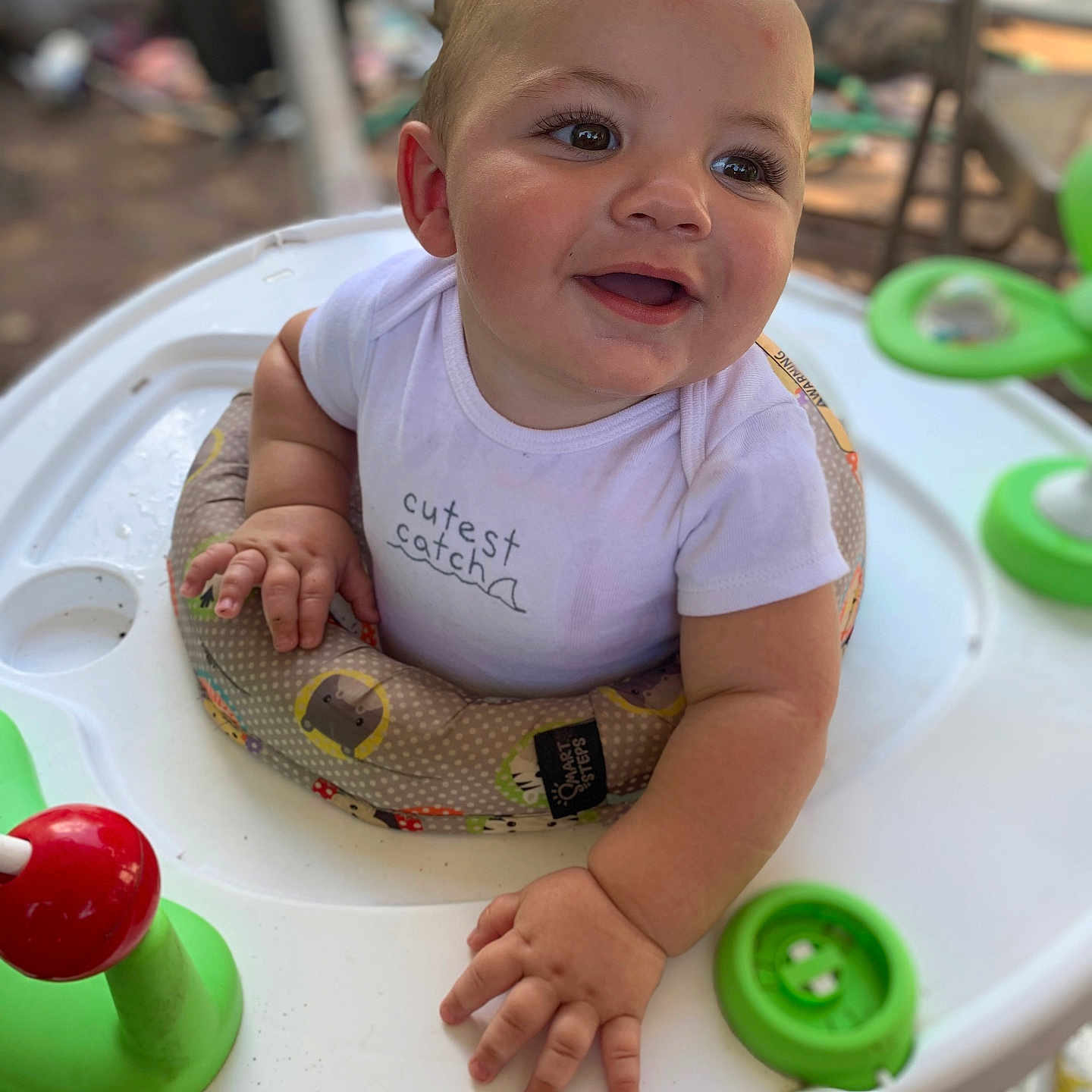 Kane is registered to the contest to win money with this photo: baby, casual, child, childhood, closeup, cute, expression, face, hands, happy, infant, joy, onesie, outdoor, playtime, seat, smiling, toy, walker, young