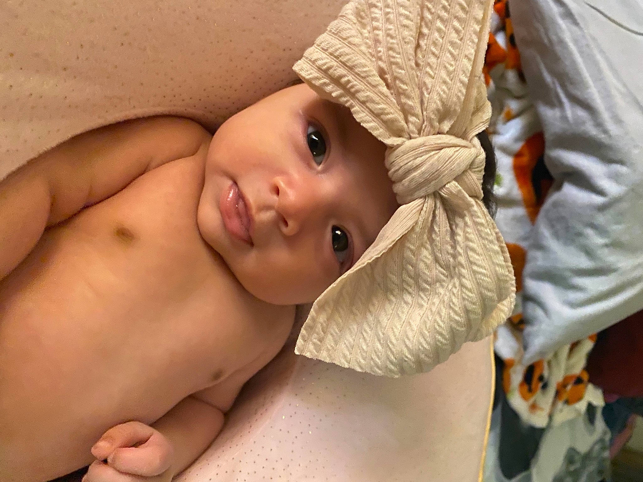 Davina is registered to the contest to win money with this photo: abdomen, baby, cheek, chest, child, comfort, eye, eyebrow, eyelash, face, gesture, happy, head, headwear, linens, lip, nose, person, skin, smile