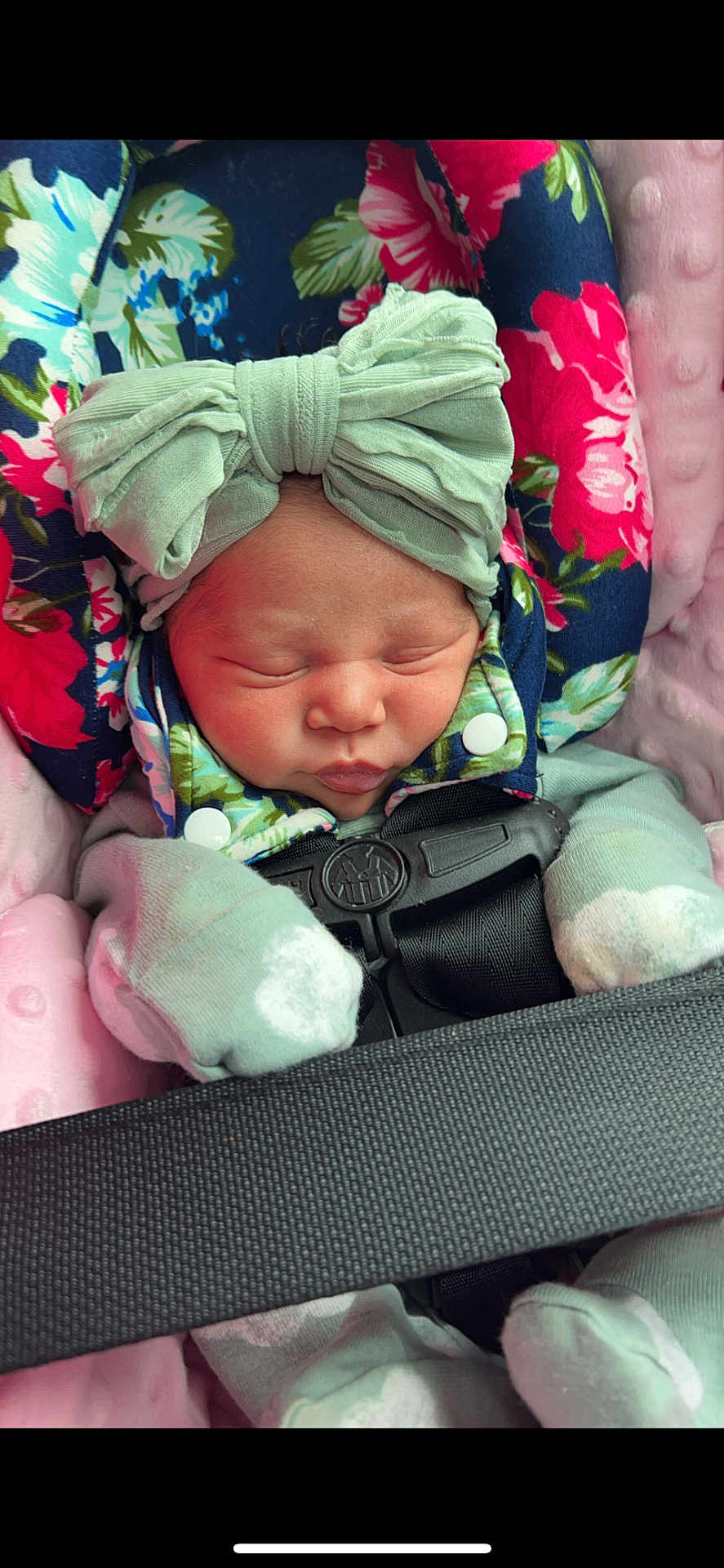 Ivori joined the competition — help win amazing prizes! newborn, baby, sleeping, headband, bow, mittens, car_seat, floral_pattern, blanket, pink, green, cozy, infant, child, face, clothing, safety_belt, portrait, closeup, cute