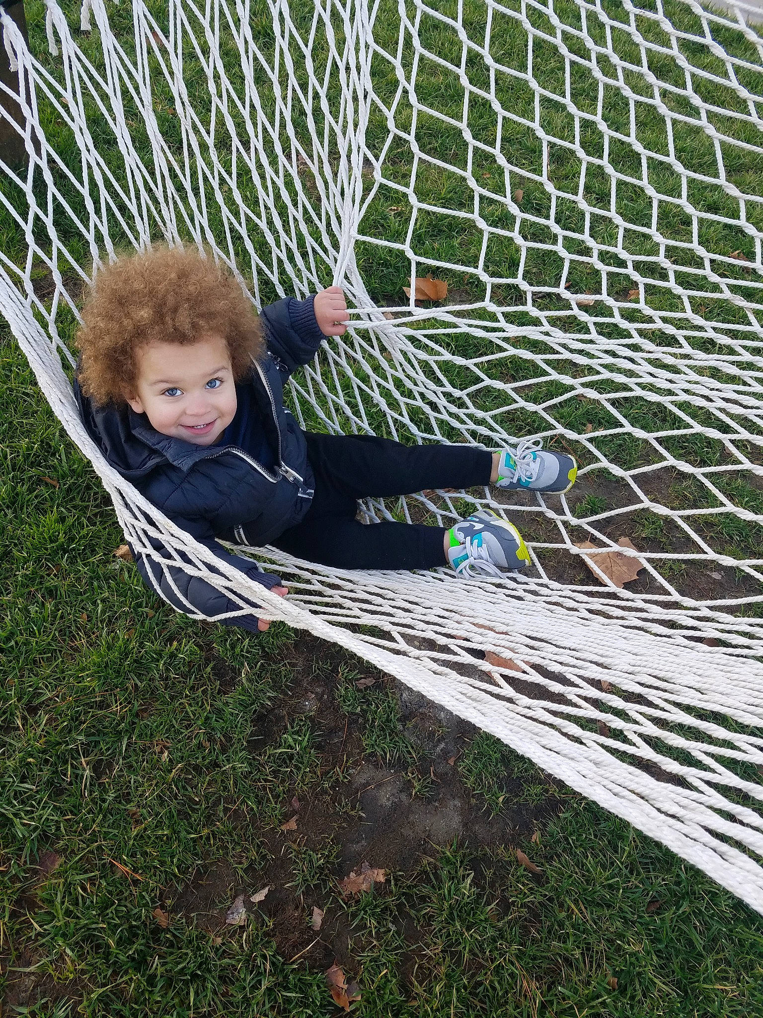 Kamari is registered to the contest to win money with this photo: child, goal, grass, hammock, joy, mesh, net, person, plant, play, player