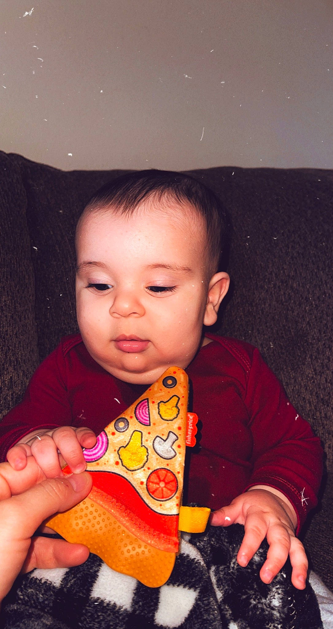 Isaias is registered to the contest to win money with this photo: baby_playing_with_toys, baby_toddler_clothing, cheek, child, eye, eyebrow, finger, hand, human, human_body, iris, lip, nail, nose, organ, person, sitting, skin, space, thumb