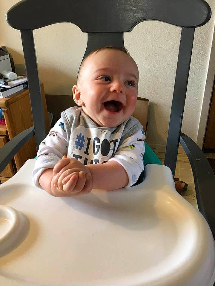 Lucius is registered to the contest to win money with this photo: baby, child, eating, furniture, person, play, product, sitting, skin, smile, toddler