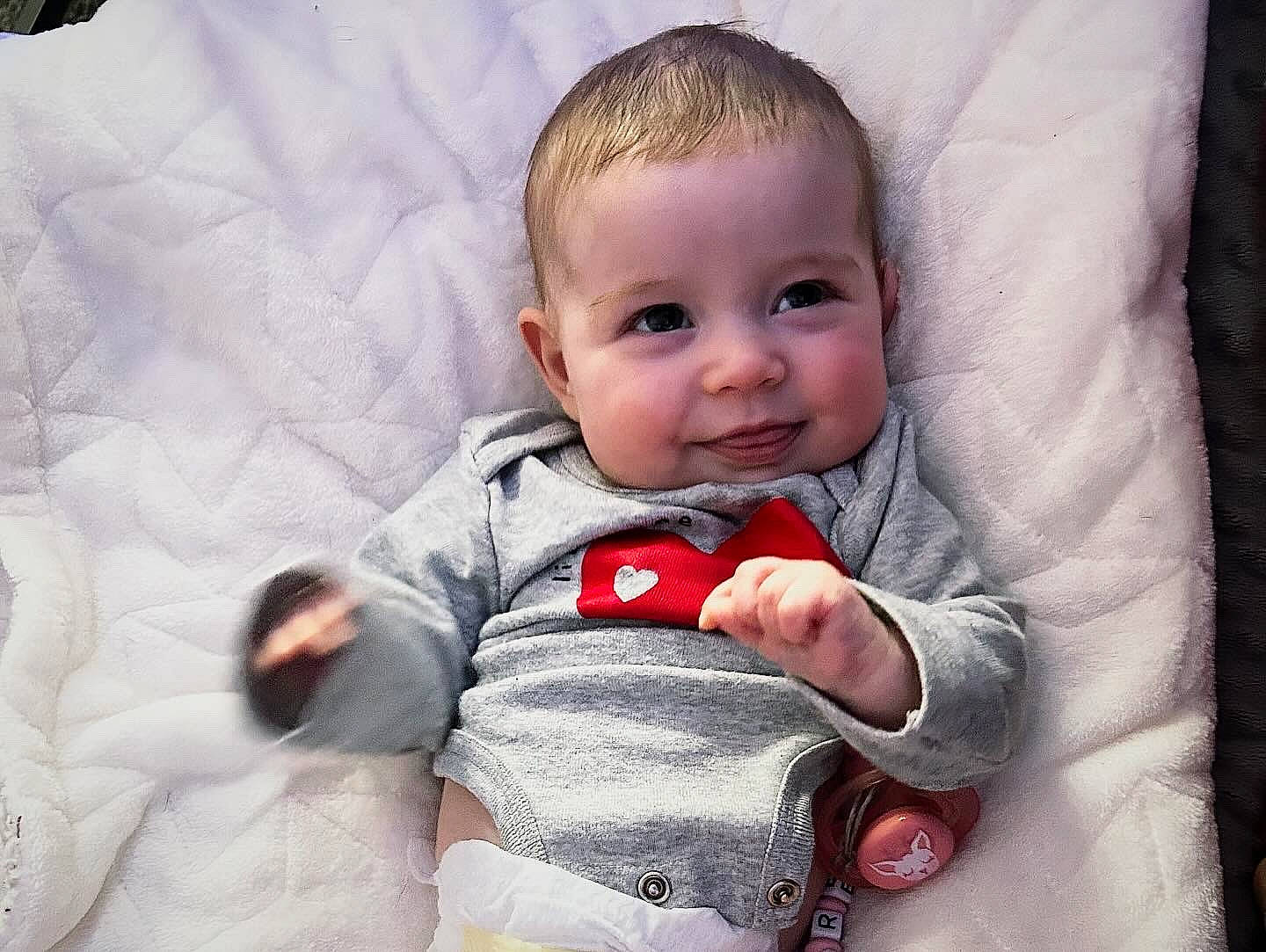 Farren is registered to the contest to win money with this photo: baby, baby_toddler_clothing, cheek, child, comfort, eye, face, fun, gesture, happy, iris, joy, linens, nose, person, product, sitting, skin, sleeve, smile