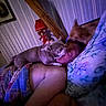 person, dog, bed, blanket, pillow, indoor, affection, sleeping, resting, pet, animal, love, cozy, home, cute, snuggling, purple_light, wood_beam, wall, lamp