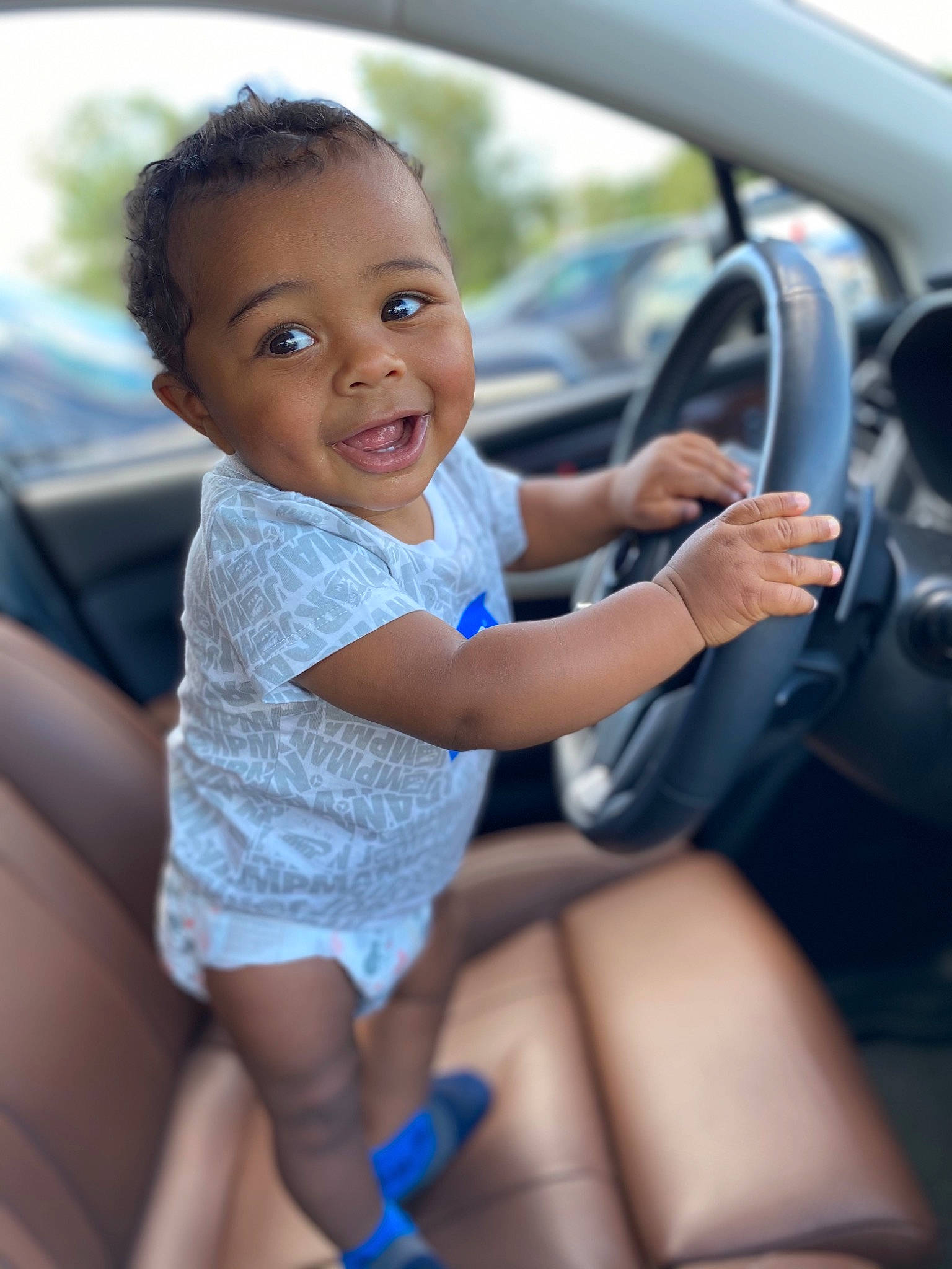 Jadon joined the competition — help win amazing prizes! auto_part, automotive_design, automotive_exterior, car, family_car, finger, flash_photography, fun, hand, happy, joy, motor_vehicle, person, personal_luxury_car, skin, smile, steering_wheel, thigh, thumb, toddler