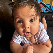 Yessiah Michelle is registered to the contest to win money with this photo: baby, child, face, eyes, hair, flower, couch, blanket, indoor, portrait, cute, curious, infant, skin, clothing, person, expression, closeup, homedecor, toddler
