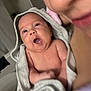 adult, baby, care, closeup, comfort, expression, face, family, happy, holding, indoor, infant, mouth_open, newborn, person, skin, smiling, soft, towel, wrapped