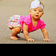Alice joined the competition — help win amazing prizes! baby, child, crawling, pink_clothing, headband, white_flower, outdoor, pavement, curious, young_child, colorful_shorts, barefoot, infant, person, cute, summer, playful, skin, portrait, daylight