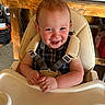 baby, cheerful, child, clothing, cute, face, furniture, happy, high_chair, home, indoor, infant, person, playful, portrait, seat, smiling, toddler, wooden_table, young_child