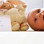 Timao a rejoint le concours — aidez-le/la à gagner de superbes lots ! baby, infant, stuffed_animal, bunny, toy, soft_toy, card, months, face, blue_eyes, lying_down, closeup, indoor, cute, child, newborn, skin, expression, head, white_background