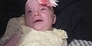 Lilyann joined the competition — help win amazing prizes! apparel, baby, baby_girl, child, cute, flower_headband, happy, headband, indoors, infant, lace, lying_down, one_person, person, portrait, small_child, smiling, soft_surface, yellow_dress, young_child