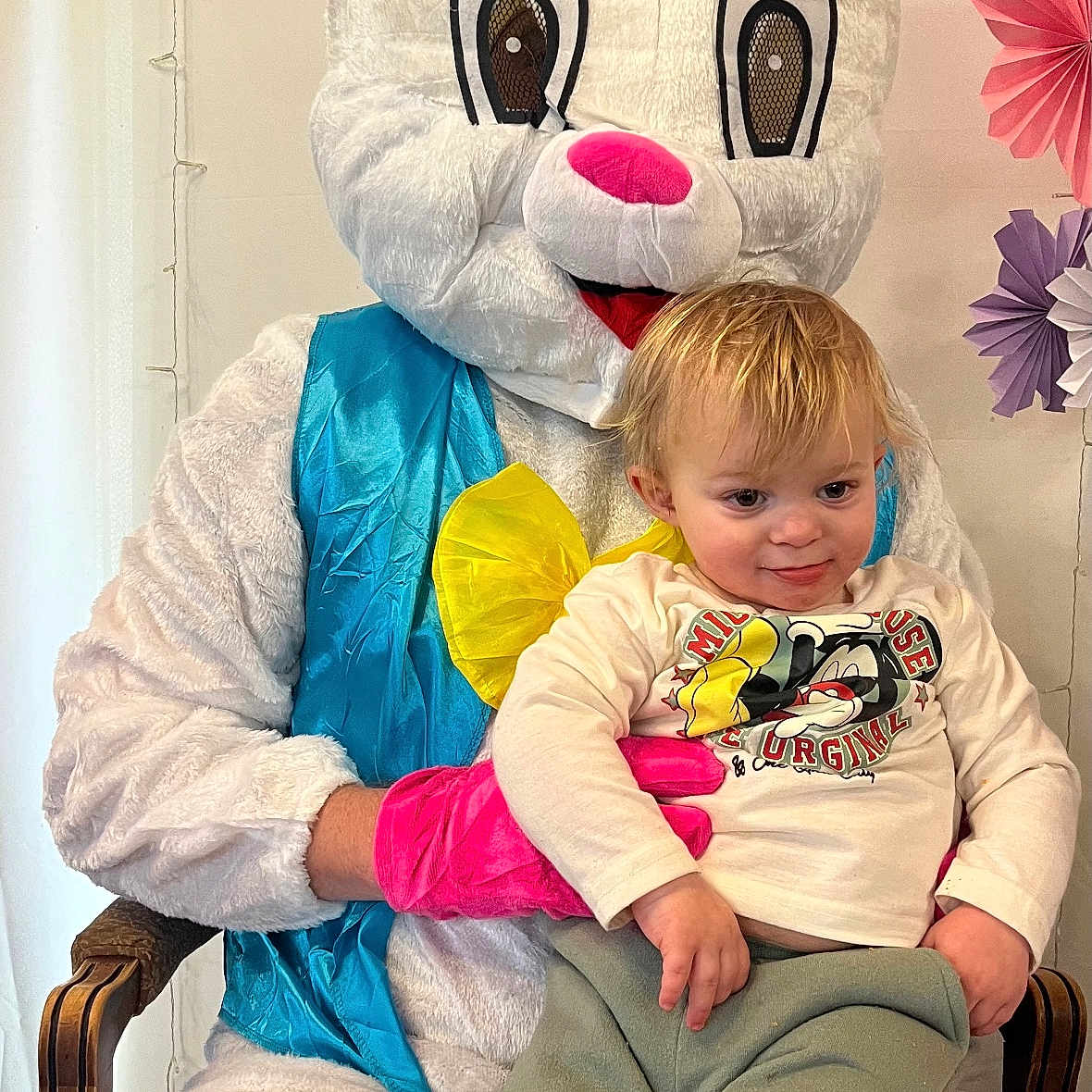 Zachery joined the competition — help win amazing prizes! child, toddler, easter_bunny, costume, person, chair, indoor, decorations, paper_flowers, pink_gloves, blue_vest, white_fur, smiling, casual_clothing, light_hair, fun_event, holiday, celebration, cute, portrait