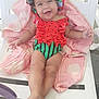 Gracelyn joined the competition — help win amazing prizes! baby, smiling, swimsuit, hat, pink_towel, white_chair, outdoor, happy, child, person, legs, feet, curly_hair, summer, relaxing, cute, playful, sunny, seat, infant