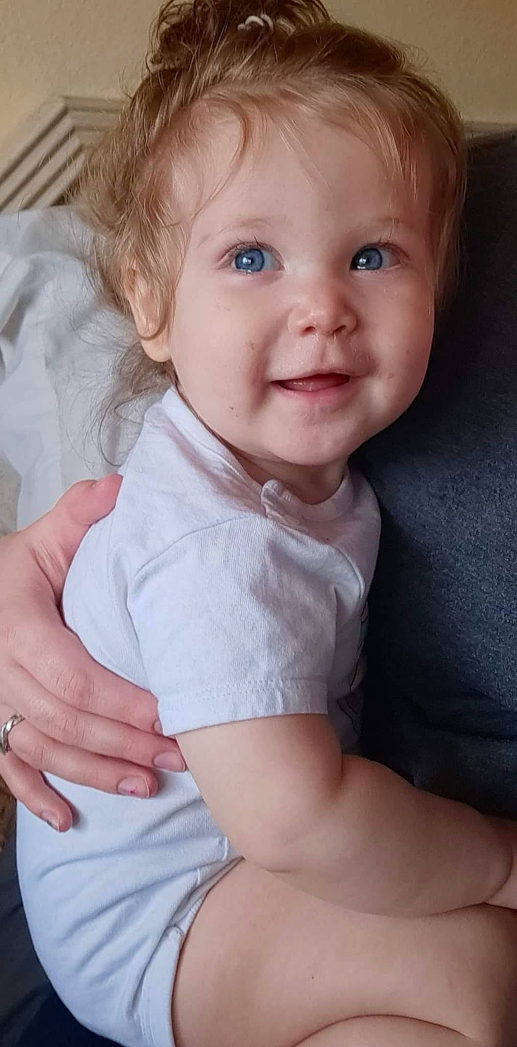 Macie is registered to the contest to win money with this photo: arm, baby_toddler_clothing, cheek, chin, eye, eyebrow, eyelash, facial_expression, hand, human_body, joint, lip, mouth, neck, nose, outerwear, person, skin, sleeve, smile