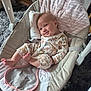 baby, smiling, onesie, baby_rocker, pillow, carpet, infant, clothing, foot, hand, face, hair, indoor, cushion, seat, relaxing, child, comfort, cute, happy
