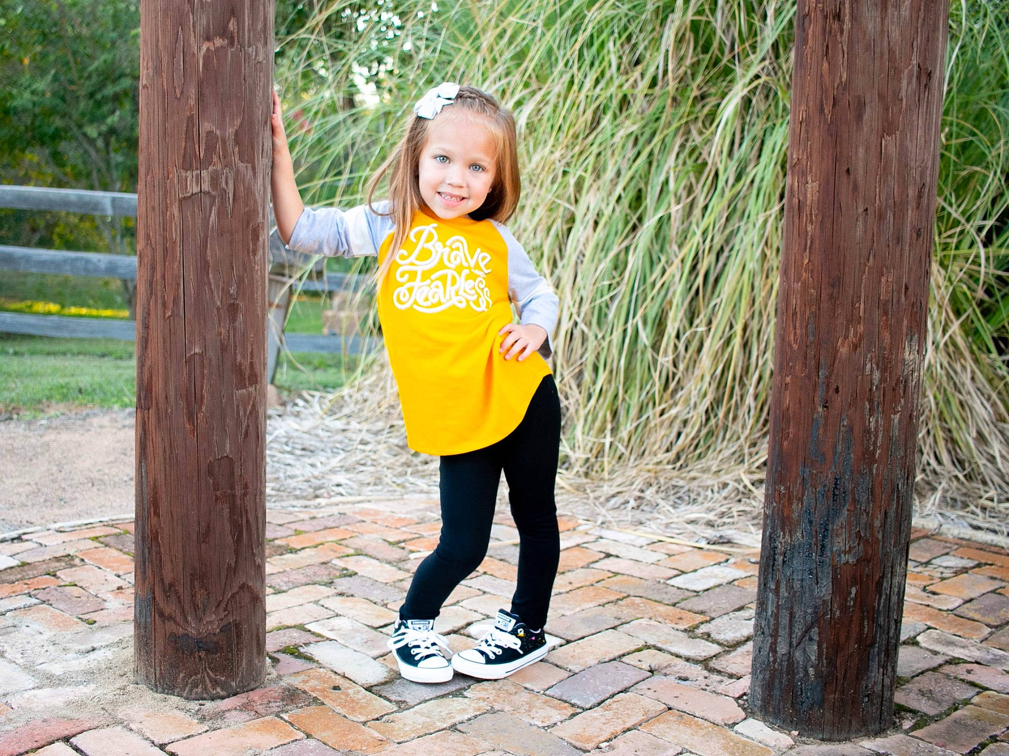 Jordynn joined the competition — help win amazing prizes! face, grass, green, happy, joy, leaf, leisure, mammal, people_in_nature, person, plant, recreation, smile, standing, street_fashion, summer, t_shirt, toddler, tree, trunk