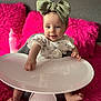 Ava joined the competition — help win amazing prizes! baby, child, high_chair, headband, bow, white_tray, pink_cushion, bottle, indoor, curious, cute, infant, person, furniture, smiling, feet, hand, clothing, soft_texture, portrait