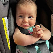 Ava joined the competition — help win amazing prizes! baby, infant, car_seat, safety_harness, pacifier, clothing, cute, chubby_cheeks, expression, face, hands, seat_belt, child, portrait, indoor, smile, skin, human, person, closeup
