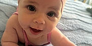 Ava is registered to the contest to win money with this photo: baby, infant, headband, flower, pink, blanket, blue, cute, smile, face, skin, arm, hand, indoors, bed, soft, child, portrait, happy, young