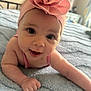 baby, infant, headband, flower, pink, blanket, blue, cute, smile, face, skin, arm, hand, indoors, bed, soft, child, portrait, happy, young
