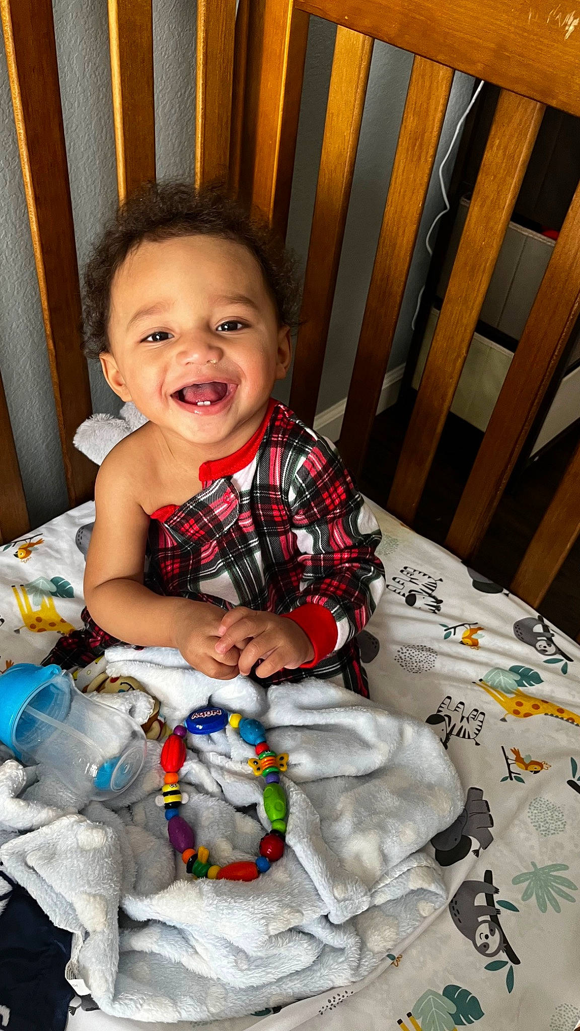 Ezra is registered to the contest to win money with this photo: baby, baby_toddler_clothing, cheek, child, comfort, eye, fun, happy, head, iris, joy, mammal, pattern, person, plaid, sitting, skin, sleeve, smile, t_shirt