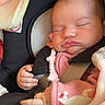 baby, sleeping, car_seat, pink_clothing, blanket, pacifier_clip, infant, child, cute, peaceful, straps, safety, newborn, face, hand, indoors, portrait, resting, cozy, soft