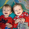 toddlers, children, twins, smiling, happy, portrait, indoors, play_mat, pajamas, spiderman, red_clothing, festive_clothing, plush_toy, elephant, toy, sitting, lying_down, siblings, close_up, colorful_background