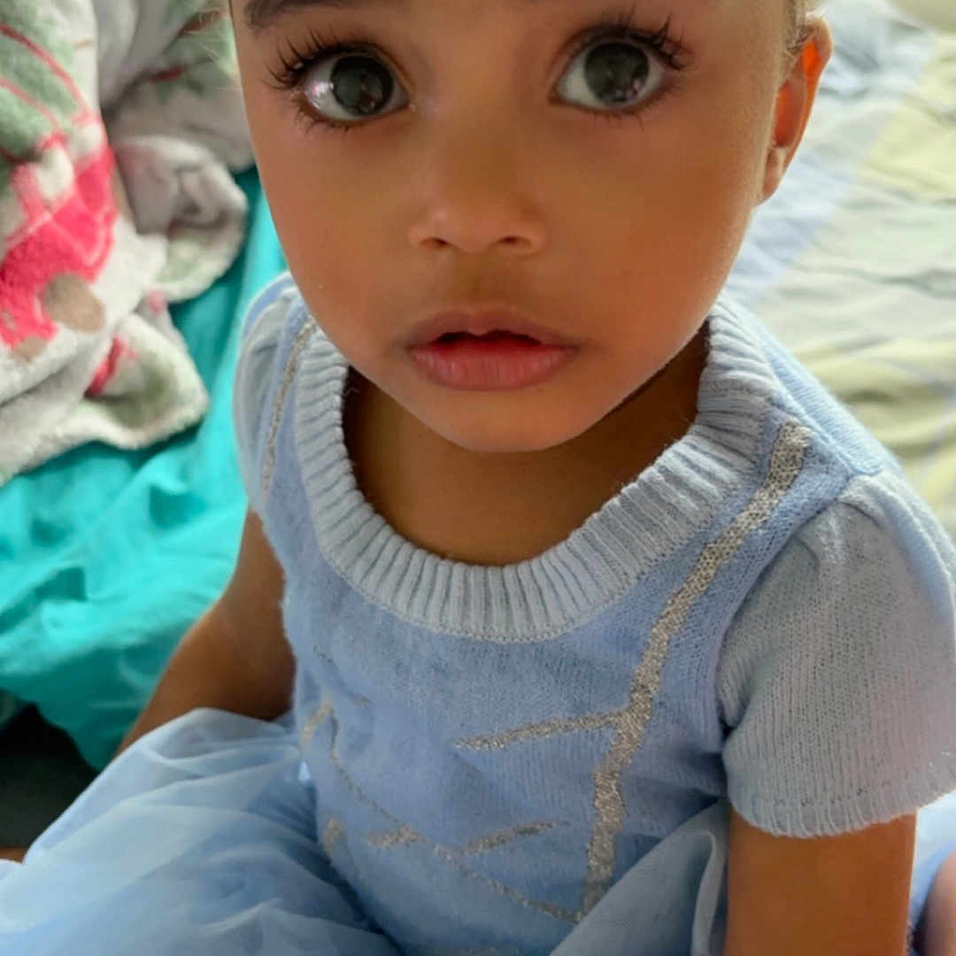 Aurora joined the competition — help win amazing prizes! baby, bed, bedroom, bodypart, clothing, couch, cushion, dress, face, frown, furniture, head, homedecor, indoors, person, photography, portrait, room, sad, sitting