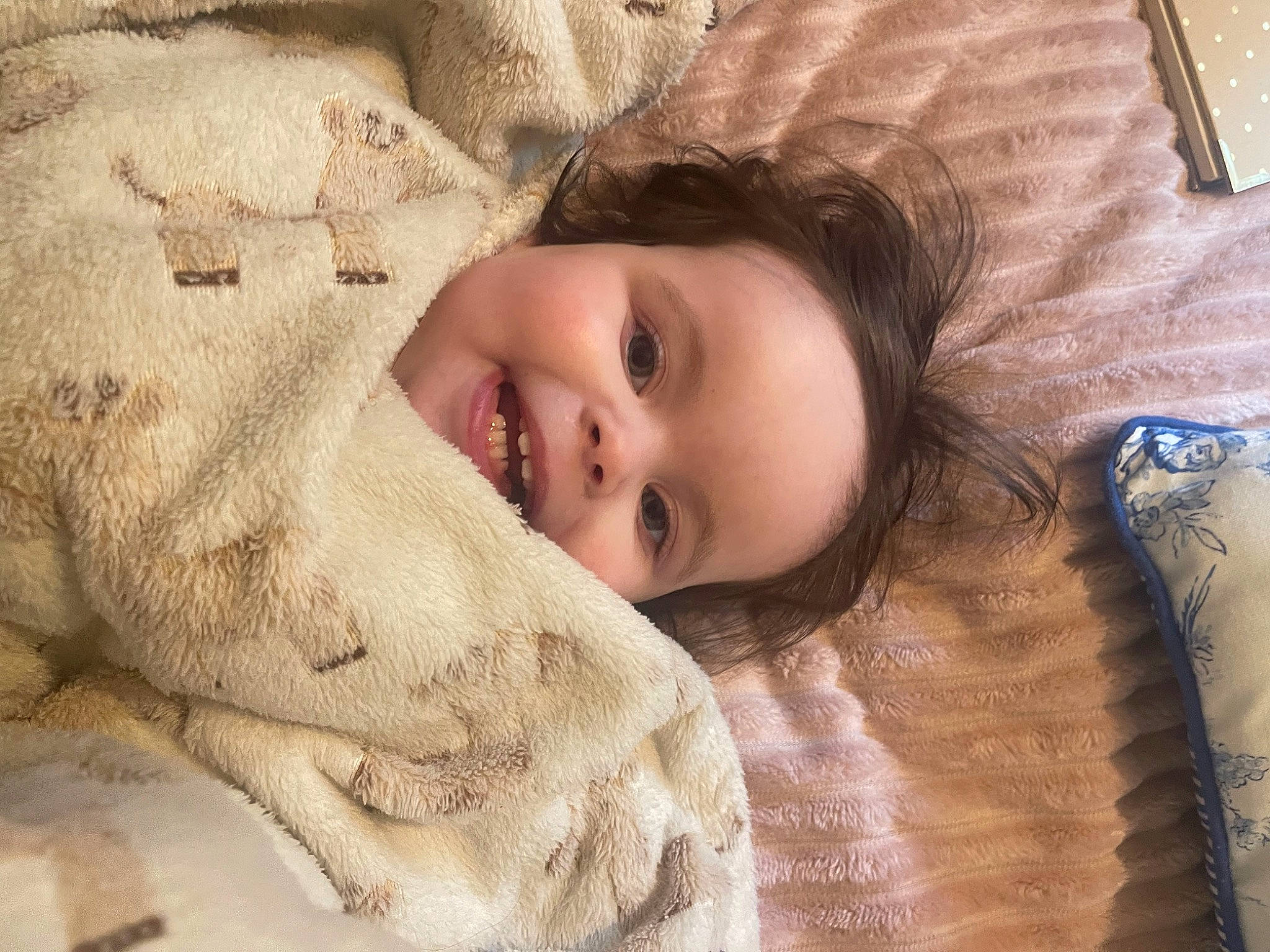 Juliet is registered to the contest to win money with this photo: child, comfort, eye, eyebrow, eyelash, happy, head, iris, linens, lip, mammal, nose, organ, person, skin, sleeve, smile, textile, toddler, vertebrate