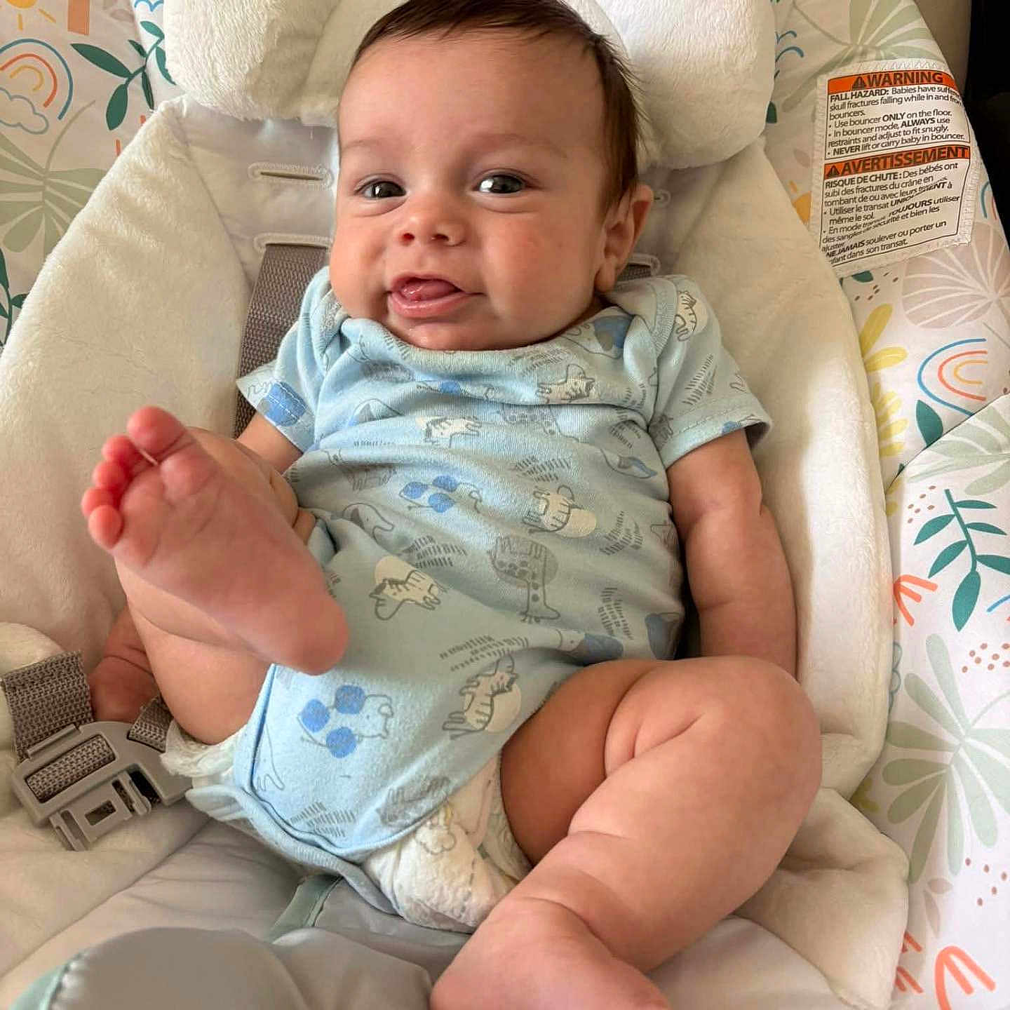 Casin Cole Delawder is registered to the contest to win money with this photo: baby, infant, onesie, foot, tongue, smile, child, cushion, seat, fabric, pattern, indoor, cute, playful, skin, person, resting, happy, head_support, straps