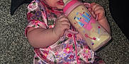 Everly joined the competition — help win amazing prizes! baby, infant, bottle, pajamas, headband, carpet, drink, milk, child, cute, pink, floral, clothing, sitting, indoors, skin, face, hand, foot, person
