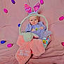 baby, basket, bunny_ears, plush_toy, easter_eggs, purple_dress, pink_background, smiling, child, holiday, cute, indoor, holiday_theme, soft_toy, celebration, festive, headwear, colorful, portrait, happy