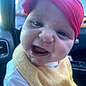 Zonasue is registered to the contest to win money with this photo: baby, child, smiling, headband, red, yellow, bib, close_up, face, happy, infant, person, car_interior, seat, clothing, portrait, cute, young_child, expression, joy