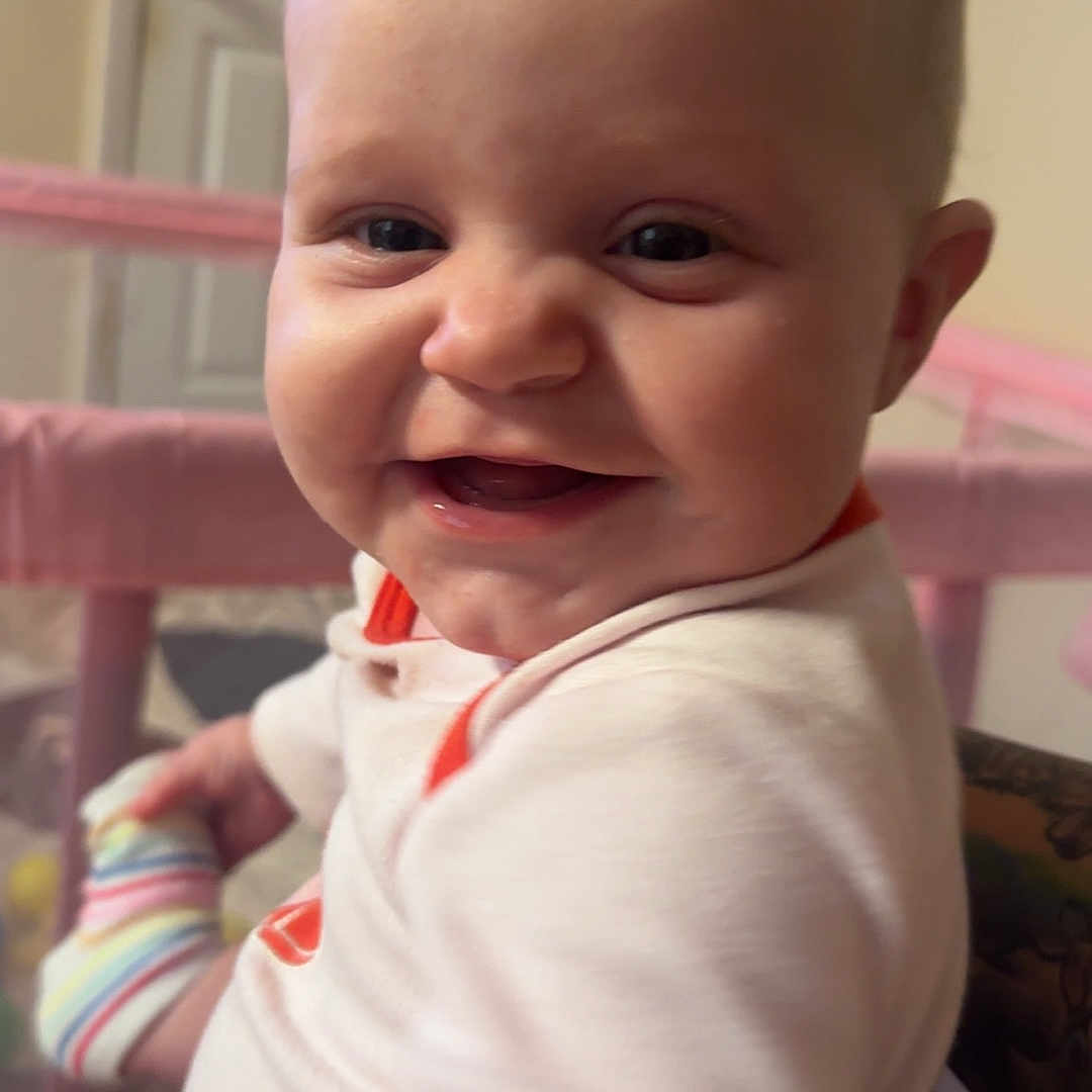Zonasue joined the competition — help win amazing prizes! baby, child, smile, face, sock, playpen, indoor, person, happy, cute, infant, clothing, hand, head, room, door, pink, colorful, holding, portrait