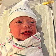 Rosaleigh joined the competition — help win amazing prizes! newborn, baby, infant, hospital, blanket, hat, bassinet, swaddled, face, expression, tongue, skin, person, cute, healthcare, bed, white, pink, green, lying