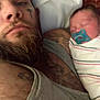baby, beard, bed, blanket, closeup, expression, family, indoor, intimate, love, man, pacifier, person, pillow, portrait, resting, skin, sleeping, swaddled, tattoo
