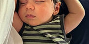 Chance joined the competition — help win amazing prizes! baby, sleeping, infant, striped_clothing, arm_raised, couch, blanket, indoor, closeup, peaceful, child, person, relaxing, soft_lighting, cozy, hair, face, head, resting, casual