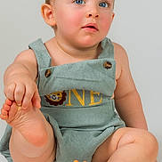 Anthuan joined the competition — help win amazing prizes! baby, child, first_birthday, cake, fondant_animals, giraffe, elephant, romper, blue_eyes, cute, portrait, indoor, celebration, sitting, foot_in_hand, phone_call_interface, white_background, birthday_cake, one_year_old, happy