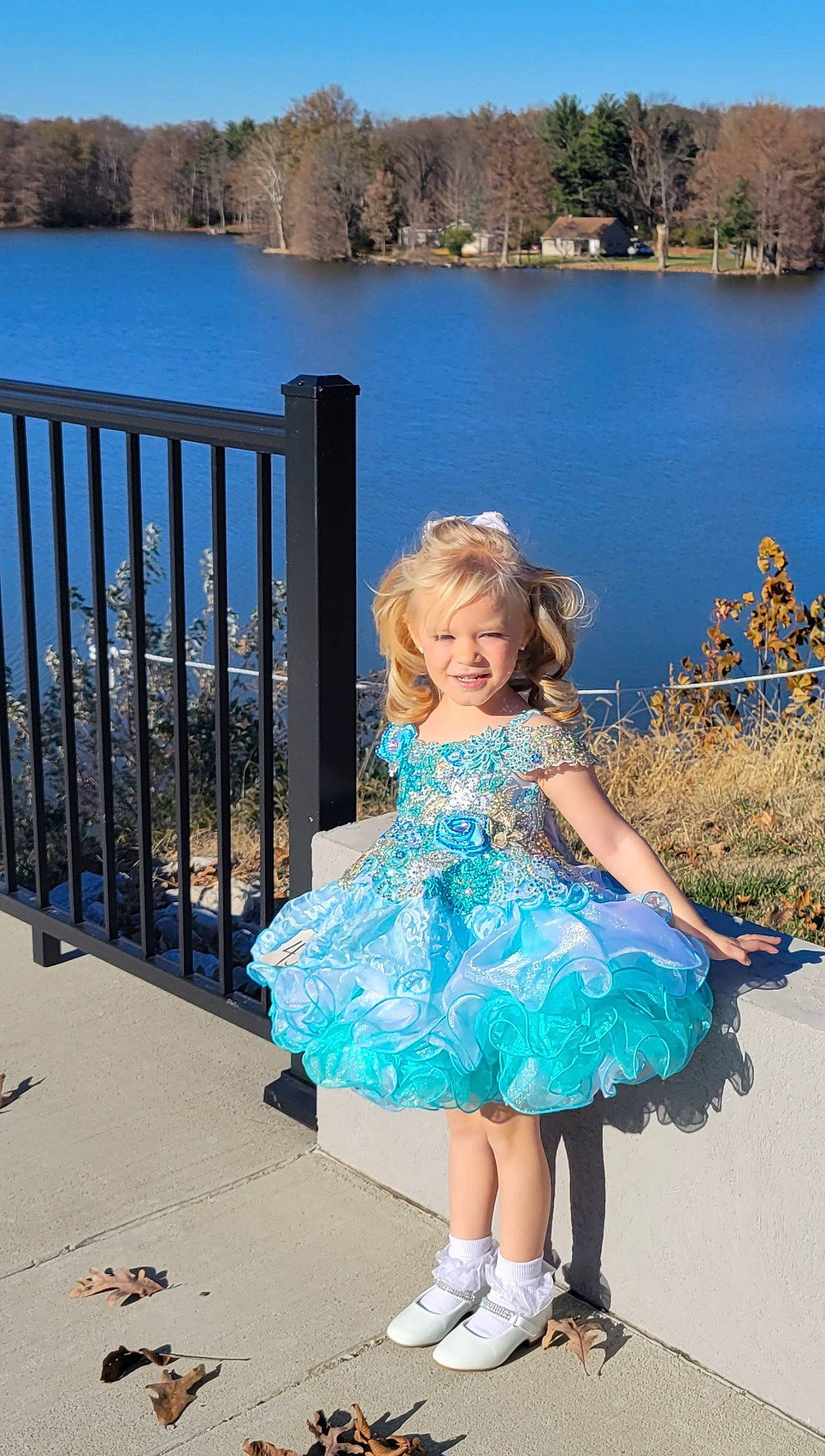 Hazelynn is registered to the contest to win money with this photo: azure, blue, day_dress, dress, electric_blue, event, fence, formal_wear, fun, grass, happy, joy, lake, leisure, person, plant, sky, smile, summer, toddler