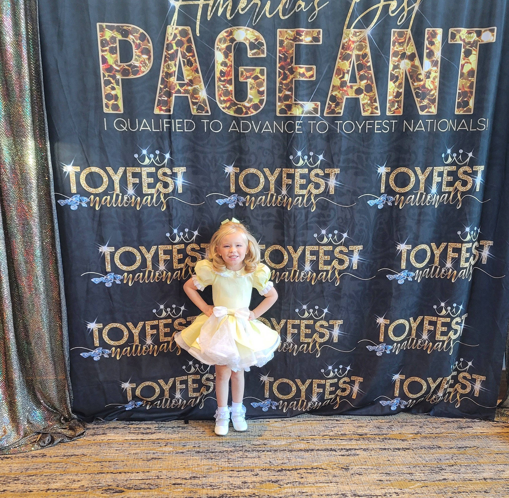 Hazelynn is registered to the contest to win money with this photo: advertising, banner, billboard, child, dress, event, fashion, fashion_design, flooring, font, fur, happy, human, joy, metal, person, sandal, signage, toddler