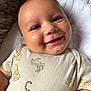 Taio is registered to the contest to win money with this photo: baby, blanket, blue_eyes, child, closeup, clothing, cute, face, happy, indoors, infant, onesie, person, portrait, skin, smiling, soft_texture, tiger, tigger, winnie_the_pooh