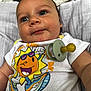 Taio is registered to the contest to win money with this photo: baby, infant, pacifier, tshirt, cartoon, sun, closeup, face, blue_eyes, clothing, cute, child, smiling, expression, indoor, fabric, soft, person, newborn, playful