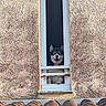 animal, architecture, building, curious, daylight, dog, ears, face, guard, husky, muzzle, narrow_window, outdoor, paw, pet, roof_tiles, rusty_bars, textured_wall, watchful, window
