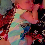 Rhydian joined the competition — help win amazing prizes! baby, sleeping, person, striped_clothing, plush_toy, hand, blanket, bed, heart_shape, indoor, soft_toy, infant, cute, closeup, resting, comfort, striped_outfit, child, holding, red_light