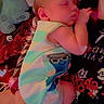 baby, sleeping, person, striped_clothing, plush_toy, hand, blanket, bed, heart_shape, indoor, soft_toy, infant, cute, closeup, resting, comfort, striped_outfit, child, holding, red_light