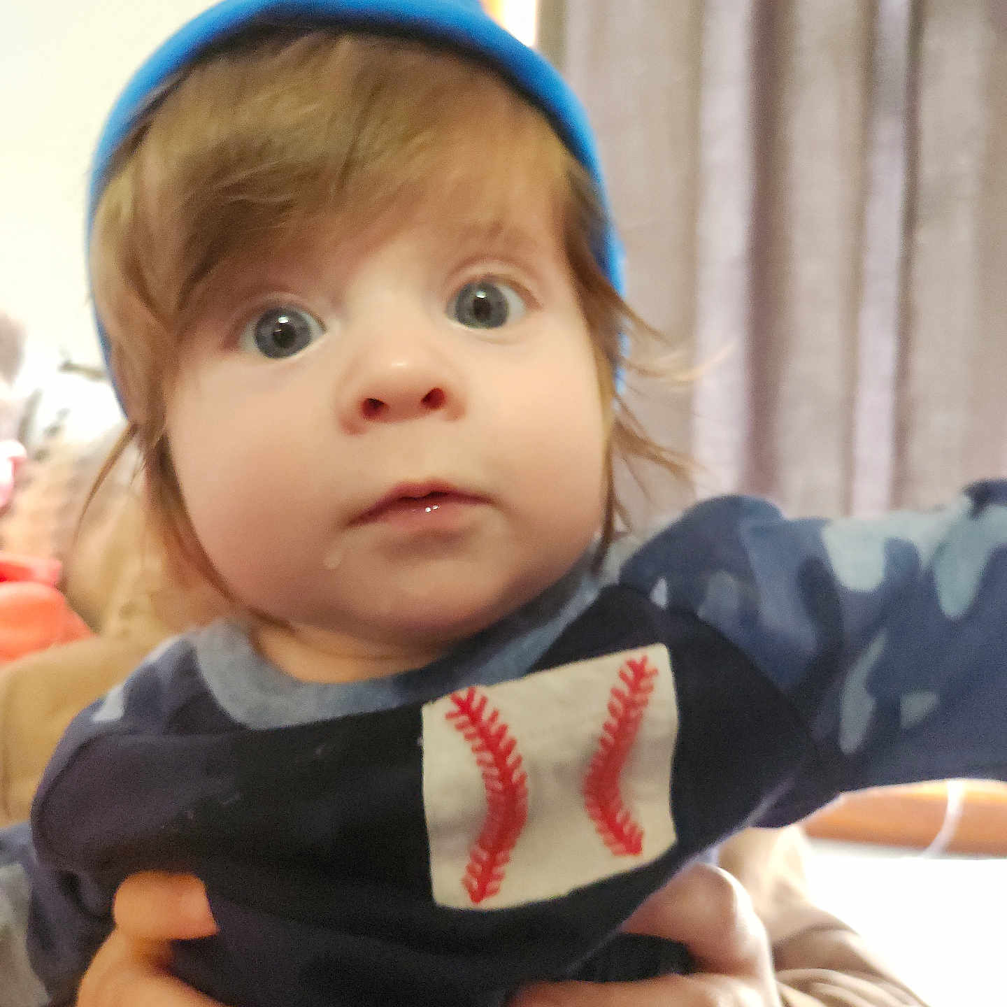 Vincent joined the competition — help win amazing prizes! toddler, child, baby, face, blue_beanie, baseball_shirt, hands, indoor, curtains, person, portrait, clothing, drool, wide_eyes, cute, holding, human, young_child, expression, casual