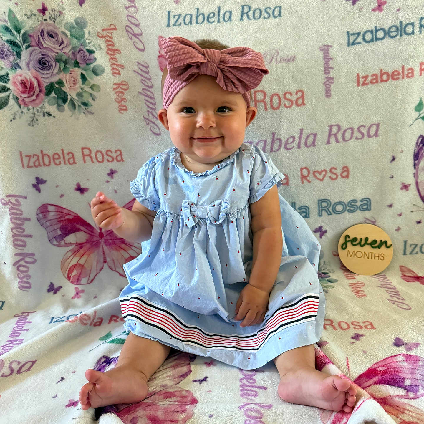 Izabela joined the competition — help win amazing prizes! baby, blanket, bow, butterfly, child, dress, flower, happy, headband, indoors, infant, milestone, name, pattern, personalized, portrait, seven_months, sitting, smiling, wooden_sign