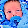 baby, infant, child, portrait, face, blue_blanket, pacifier, wide_eyes, indoors, close_up, sleepwear, wrapped, cozy, soft_texture, head, eyes, nose, mouth, blue, photography