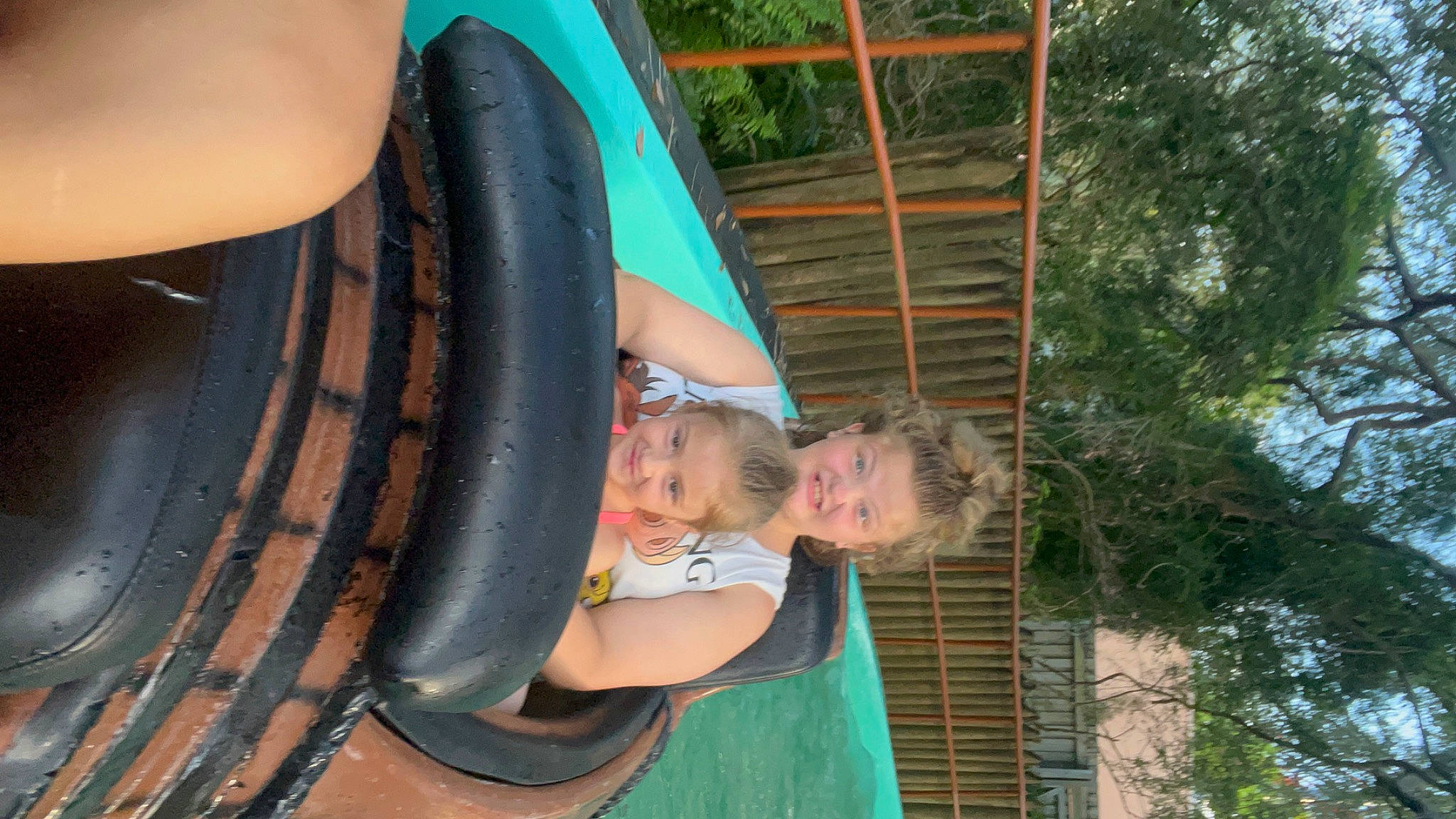 Hailey is registered to the contest to win money with this photo: automotive_tire, bicycle_tire, fun, green, hand, joy, leisure, outdoor_play_equipment, people, person, playground_slide, public_space, recreation, smile, summer, synthetic_rubber, thigh, tire, tire_care, tread